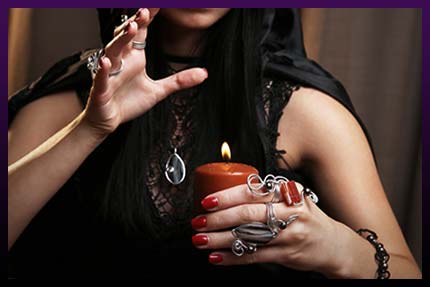 Witch casting love with candle